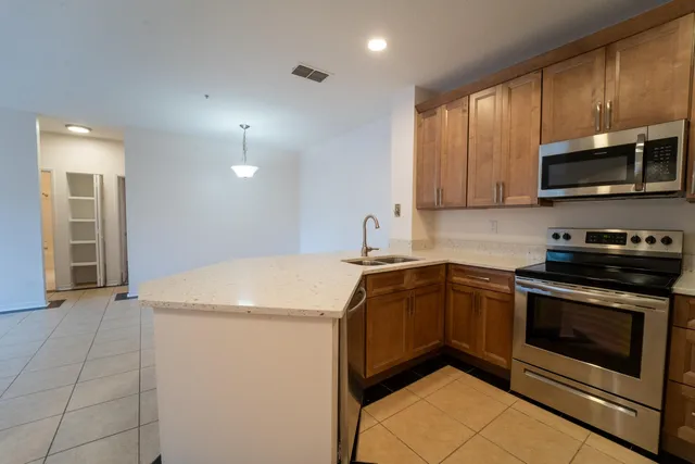 a kitchen with stainless steel appliances granite countertop a sink and a stove top oven with granite countertops