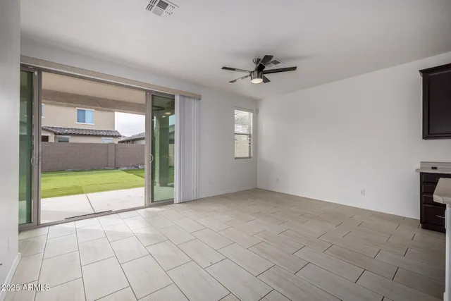 a view of an empty room with a fireplace and a window