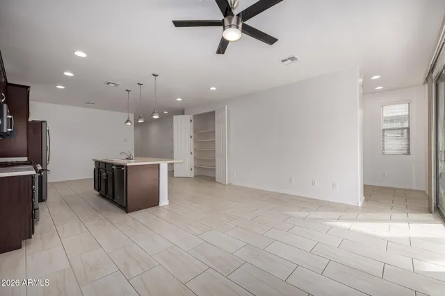 a large kitchen with a large counter top and stainless steel appliances