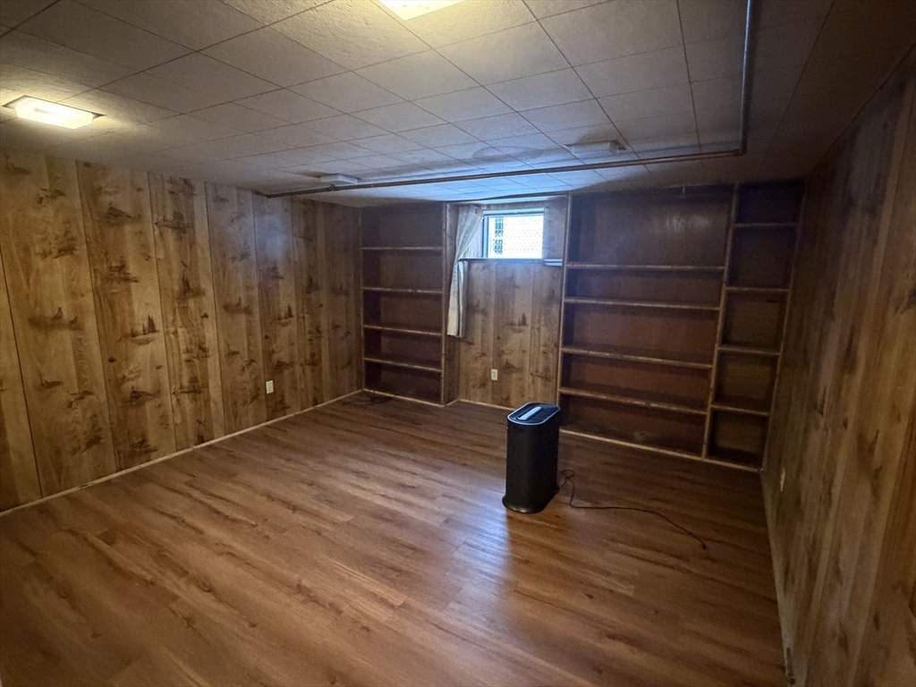 34 Adams Avenue Saugus, MA 01906 - Photo 3 of 8 a view of empty room with wooden floor and empty shelves