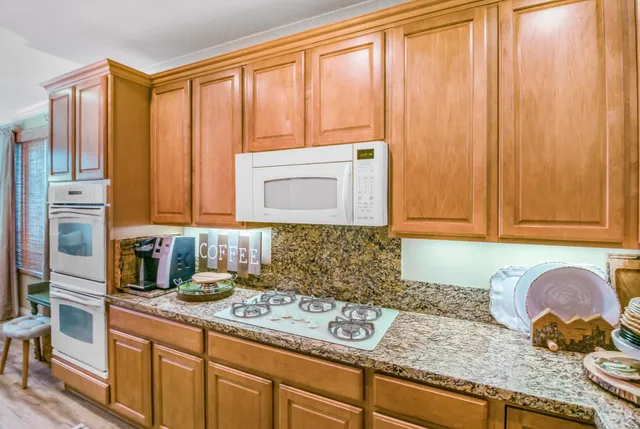 a kitchen with granite countertop cabinets and black stainless steel appliances