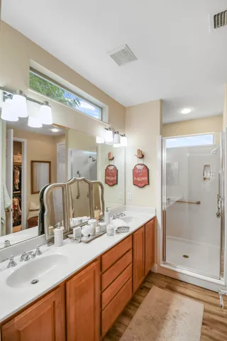 a bathroom with a double vanity sink and a mirror