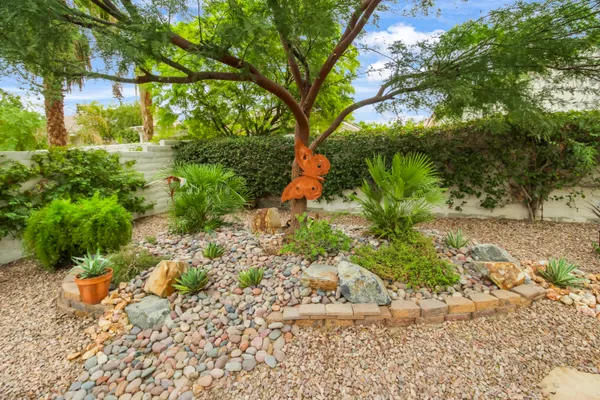 a backyard of a house with a yard and outdoor seating