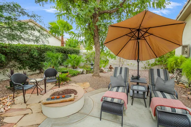 a patio with a patio table and chairs