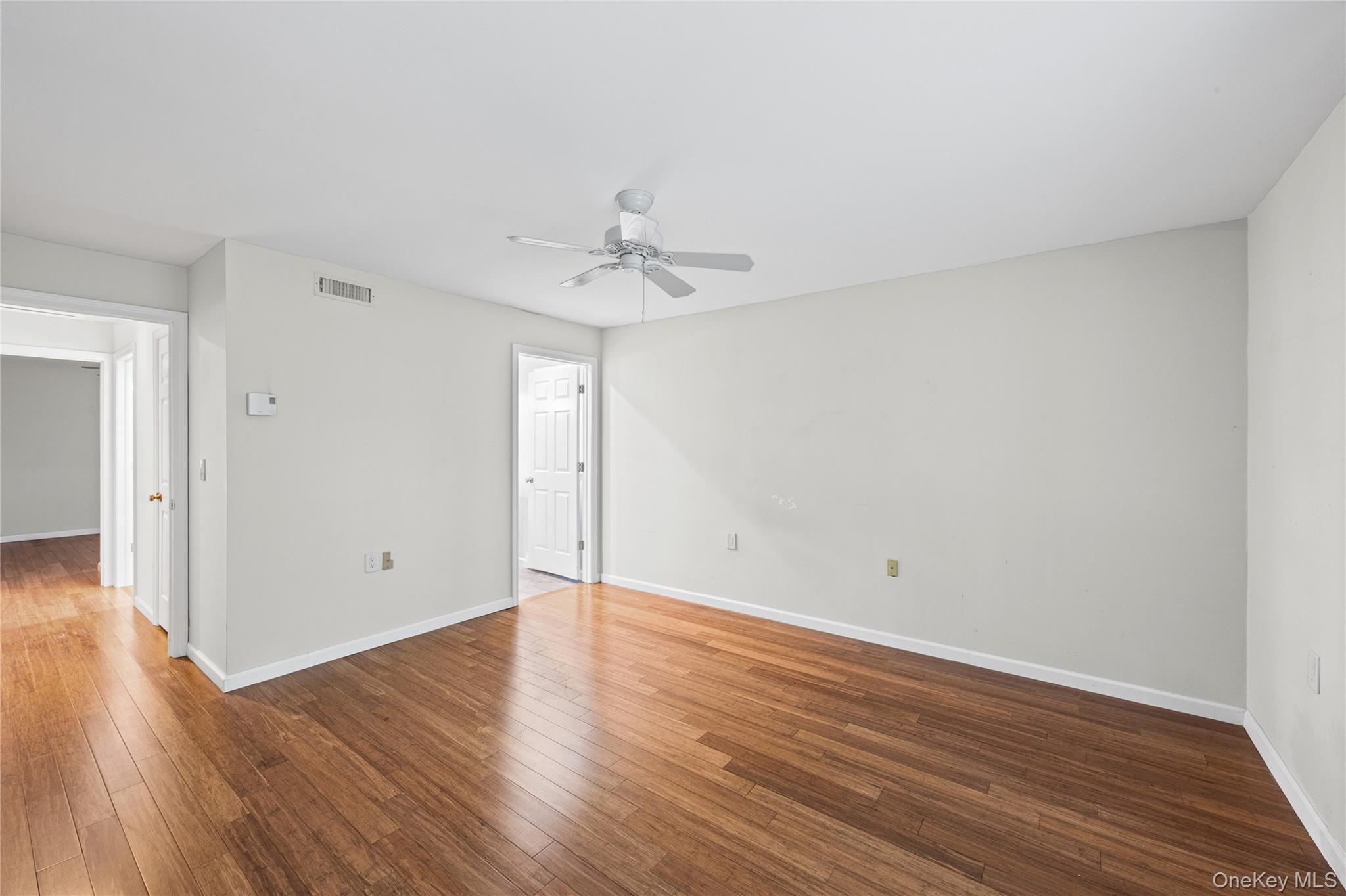 220 Belfast Lane Ridge, NY 11961 - Photo 33 of 44 a view of an empty room with wooden floor