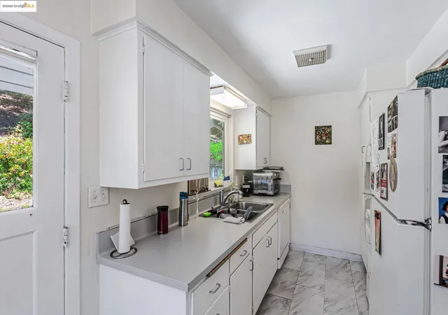 a kitchen with a sink stove and refrigerator