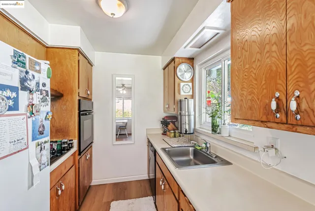 a kitchen with a sink a stove and a refrigerator