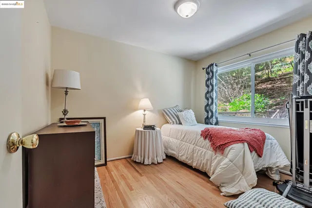 a bedroom with bed and a large window