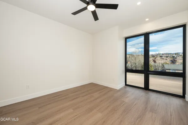 a view of empty room with wooden floor