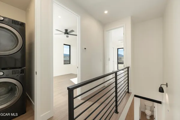 a view of a hallway with wooden floor