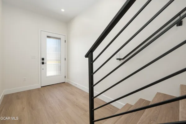 a view of staircase with white walls and a window