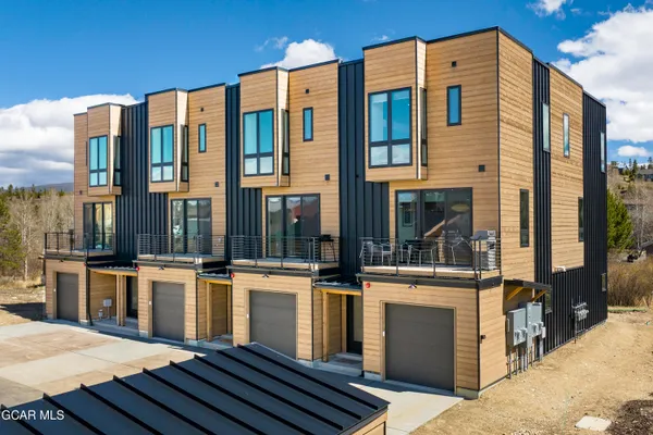a view of a yard with wooden fence