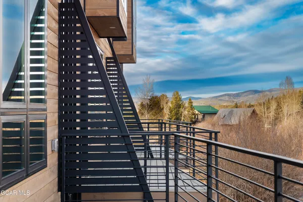 a view of a balcony with a potted plant on a brick wall
