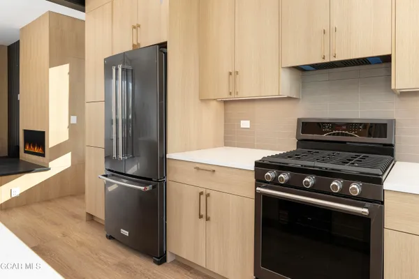 a kitchen with a stove and a microwave