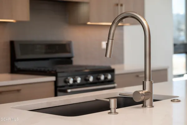 a stove top oven sitting inside of a kitchen