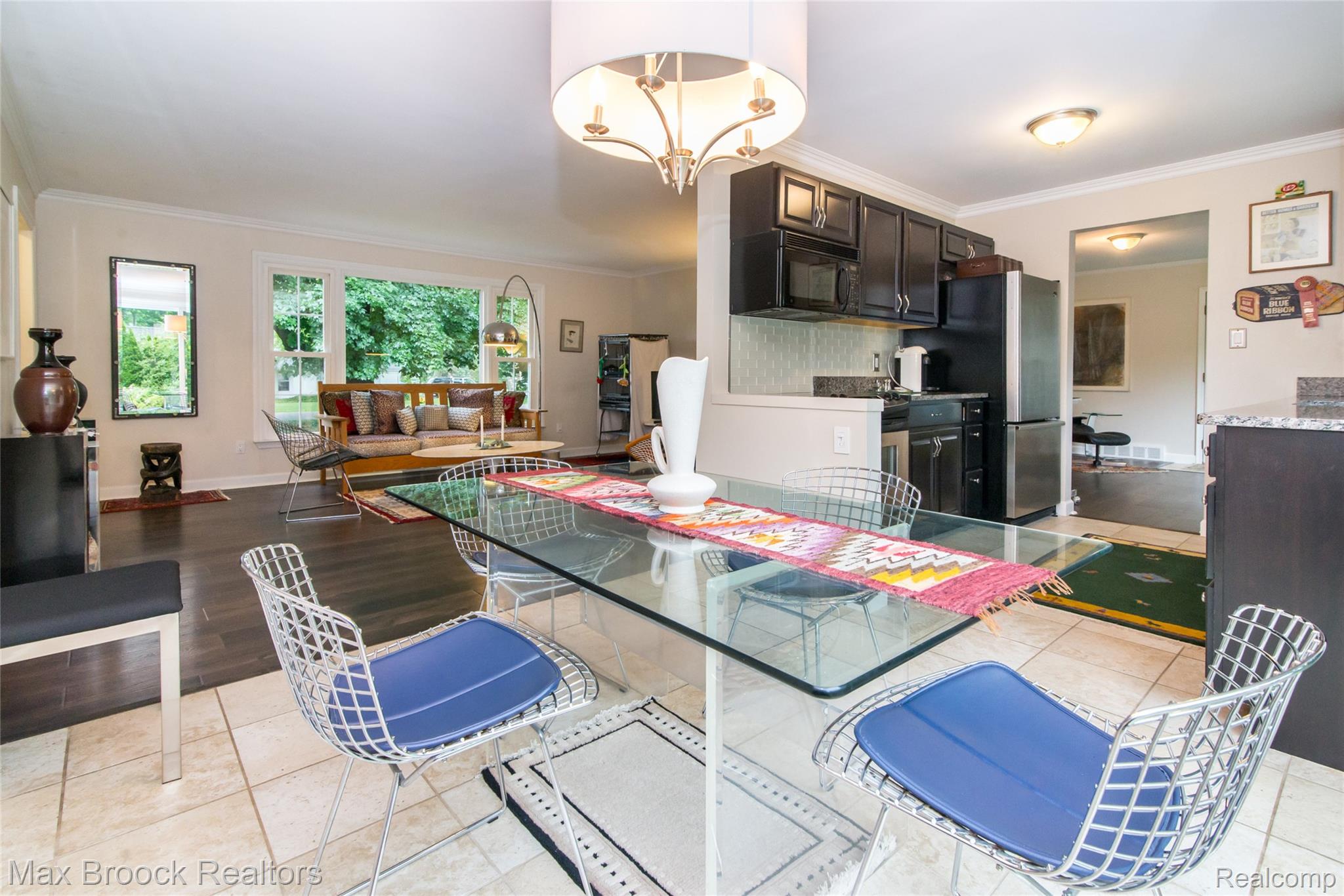 6799 East Dartmoor Road West Bloomfield, MI 48322 - Photo 8 of 36 Dining area featuring a glass-top table, tile flooring, and an overhead chandelier