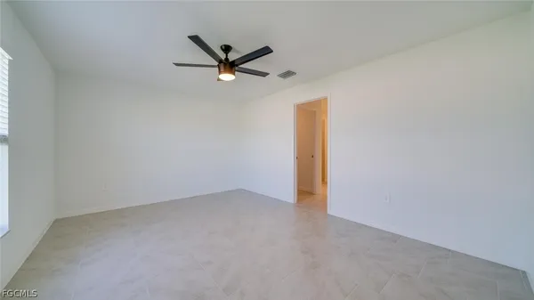 a view of a room with a ceiling fan and a window