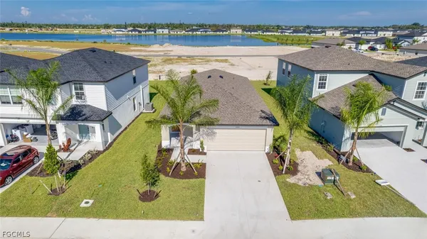 an aerial view of a house with a swimming pool and outdoor space