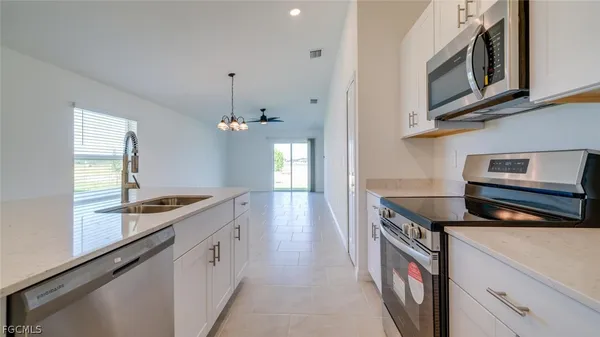 a kitchen with granite countertop a stove and a sink