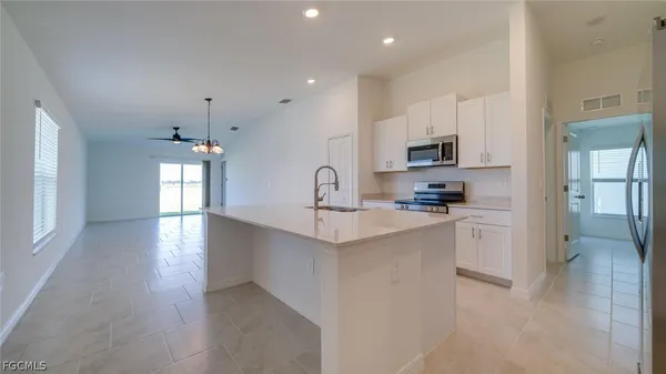 a kitchen with refrigerator and window