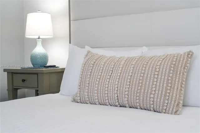 a bedroom with a bed and a lamp on table