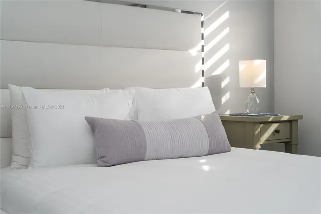 a bedroom with a bed and a night stand