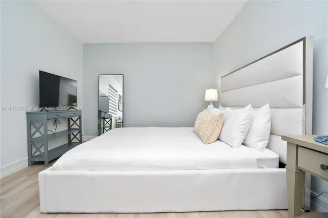 a bedroom with a bed and a lamp