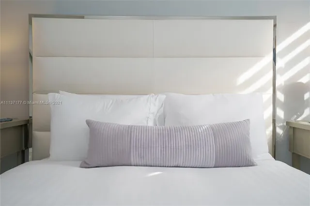 a bedroom with a bed and a lamp