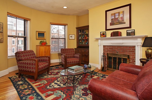 a living room with furniture wooden floor and a fireplace