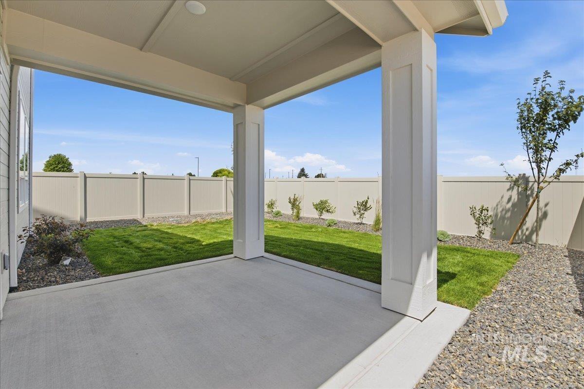 3405 Elliptical Lane Caldwell, ID 83607 - Photo 12 of 17 Covered patio with a concrete surface, manicured lawn, and perimeter fencing