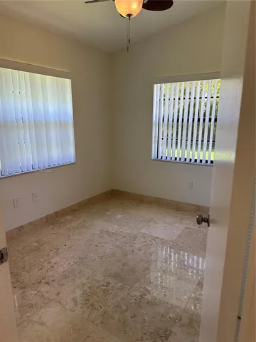 a view of an empty room with windows