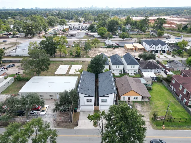 an aerial view of residential houses with outdoor space