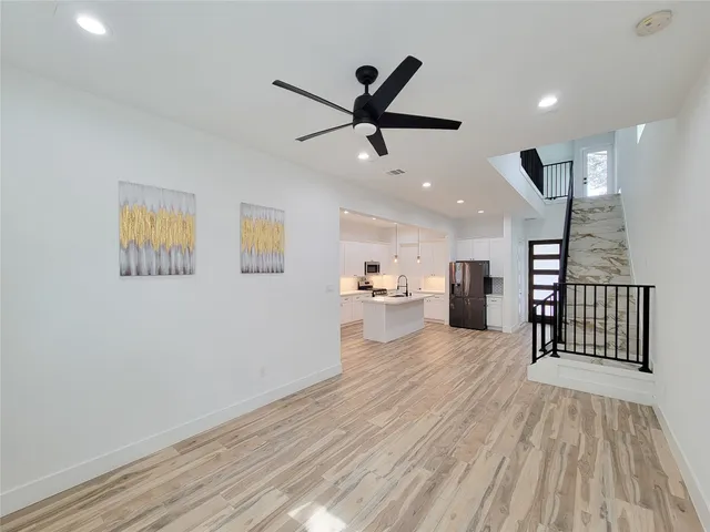 a kitchen with stainless steel appliances a refrigerator and a stove top oven