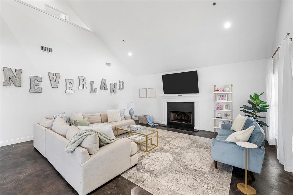 2016 South 11th Street Waco, TX 76706 - Photo 3 of 40 living area with fireplace and open layout with vaulted ceiling