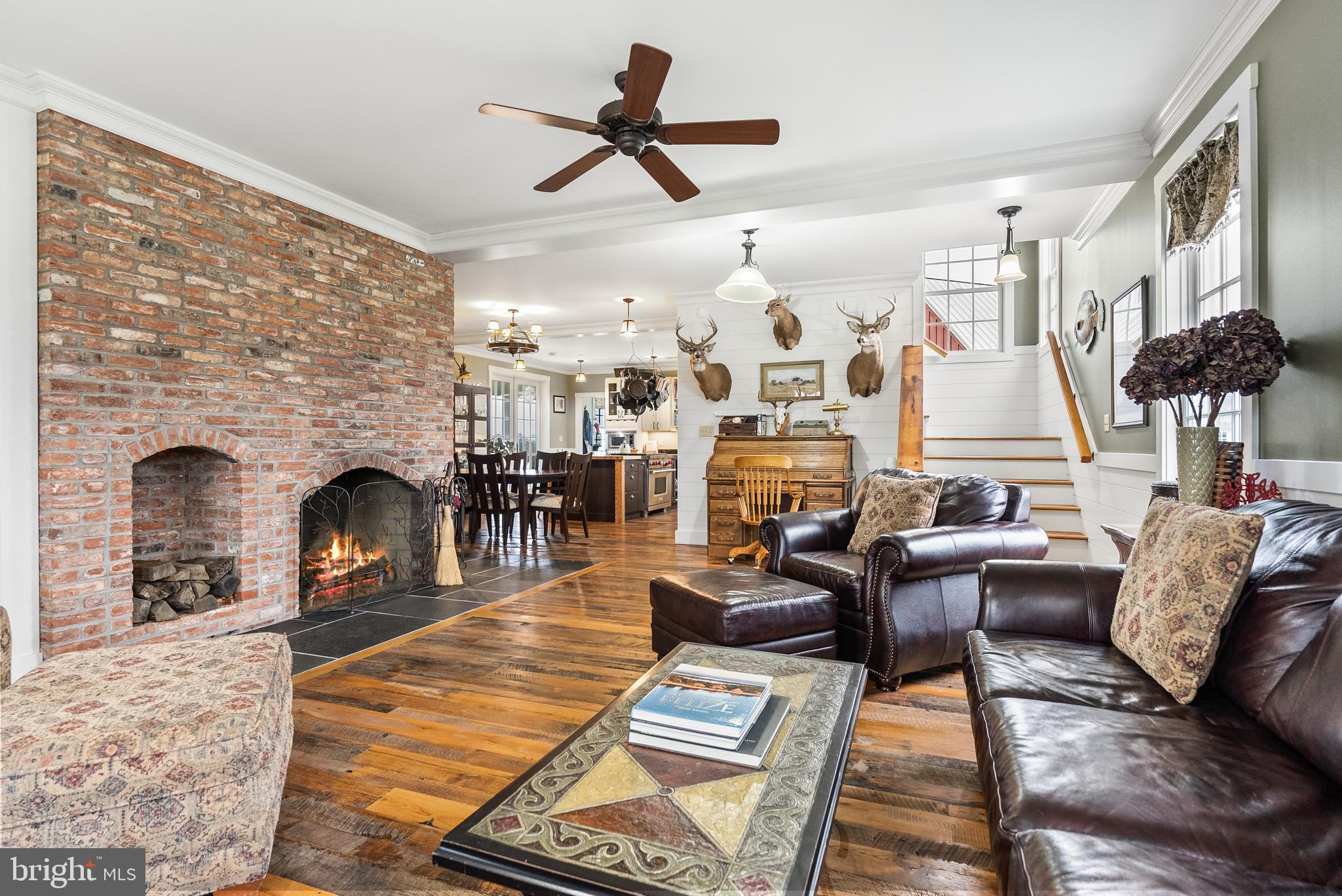 21100 West Offutt Road Poolesville, MD 20837 - Photo 16 of 58 a living room with furniture a fireplace and a flat screen tv