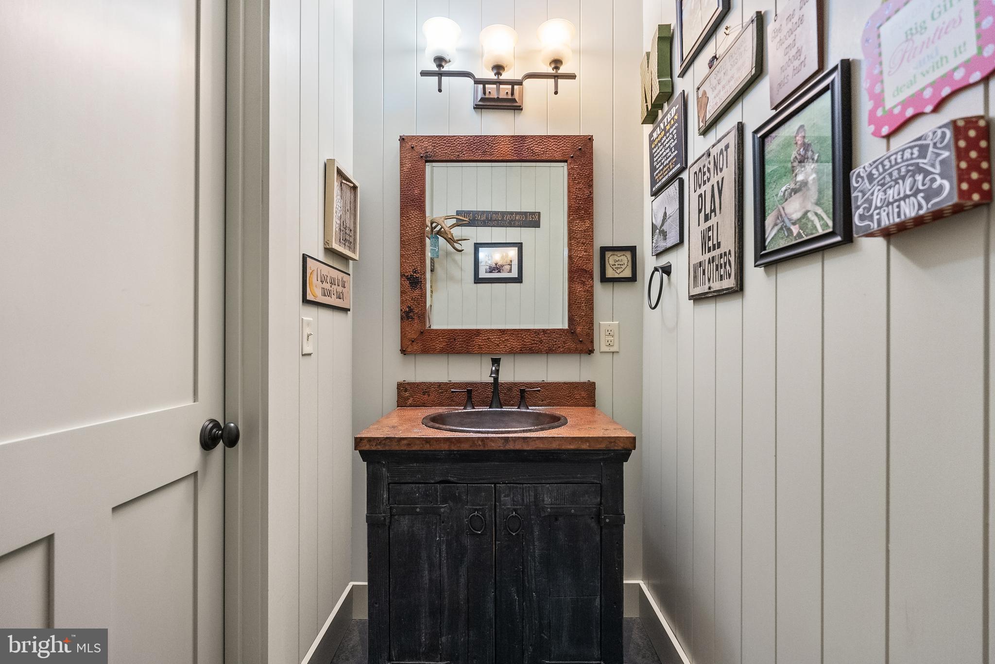 21100 West Offutt Road Poolesville, MD 20837 - Photo 21 of 58 a bathroom with a sink and a mirror