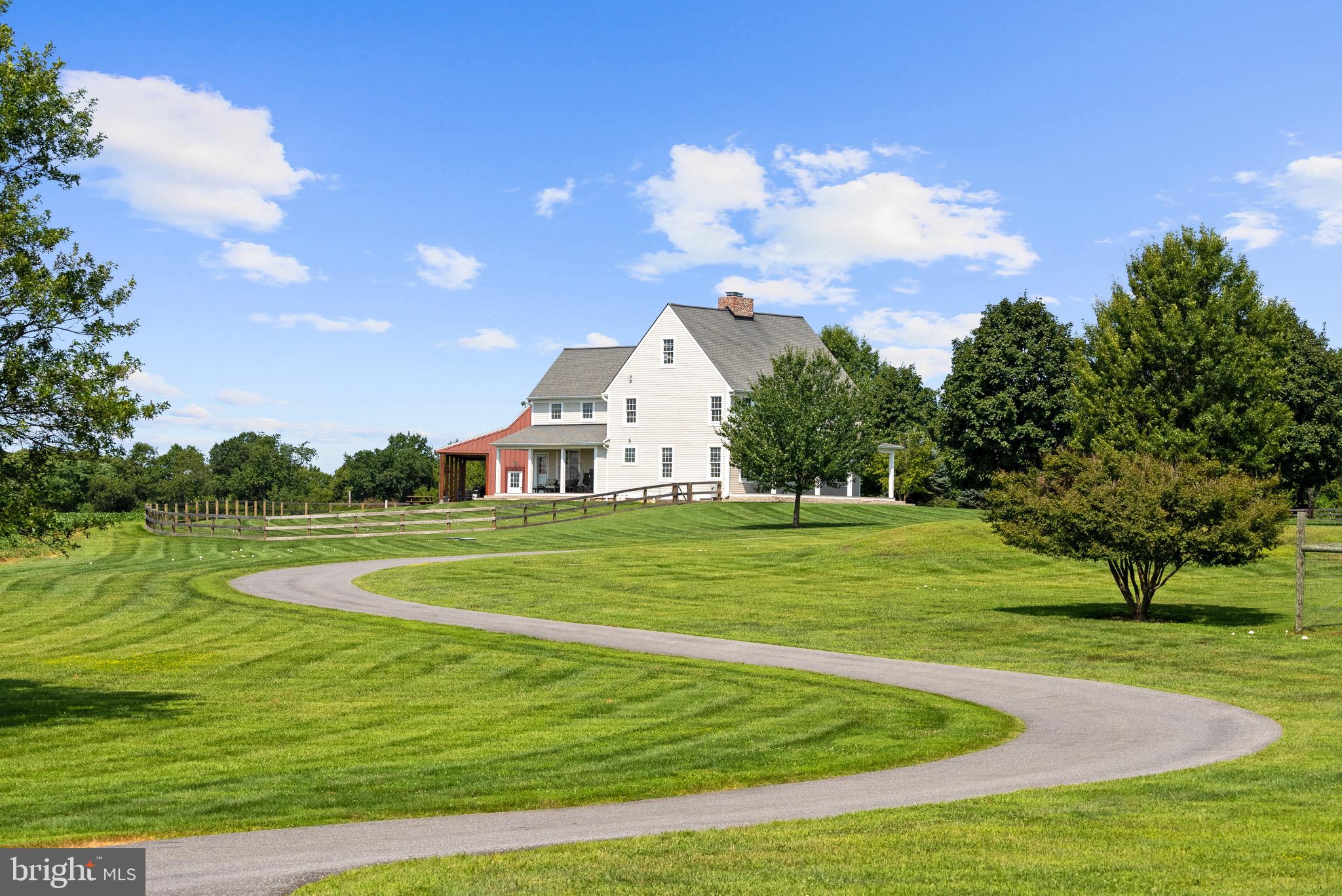 21100 West Offutt Road Poolesville, MD 20837 - Photo 29 of 58 a view of a white house with a big yard and potted plants