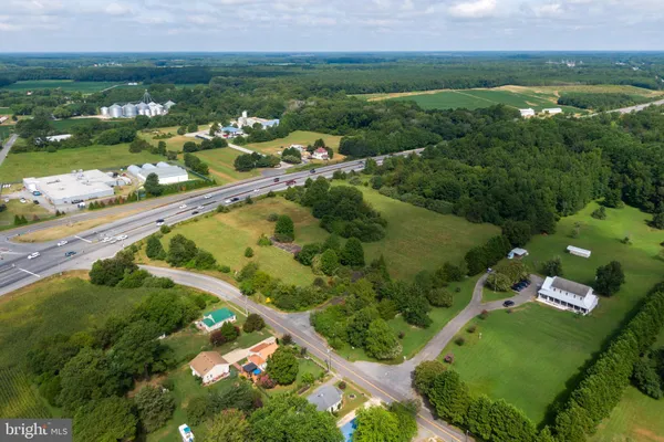 an aerial view of river residential houses with outdoor space and swimming pool