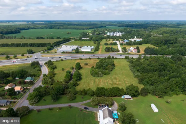 an aerial view of a residential houses with outdoor space and street view