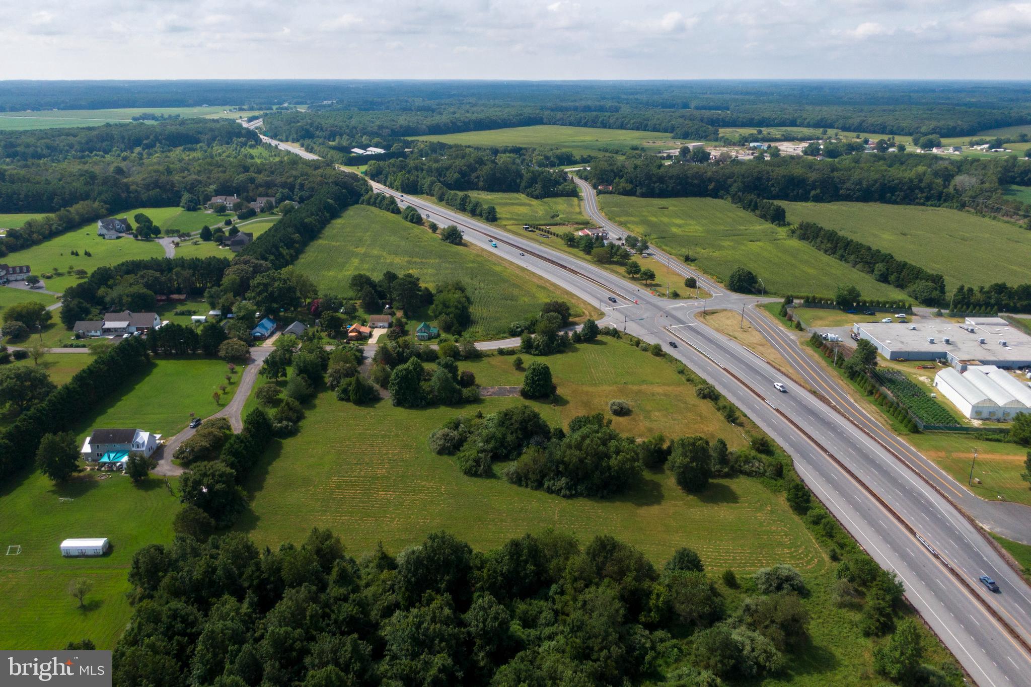 Cove Landing Road Bishopville, MD 21813 - Photo 9 of 12 an aerial view of a city with lots of residential buildings and mountain and ocean view in back