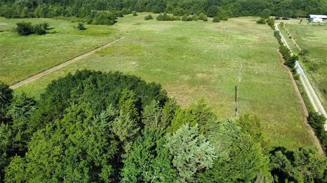a view of a field with an ocean view