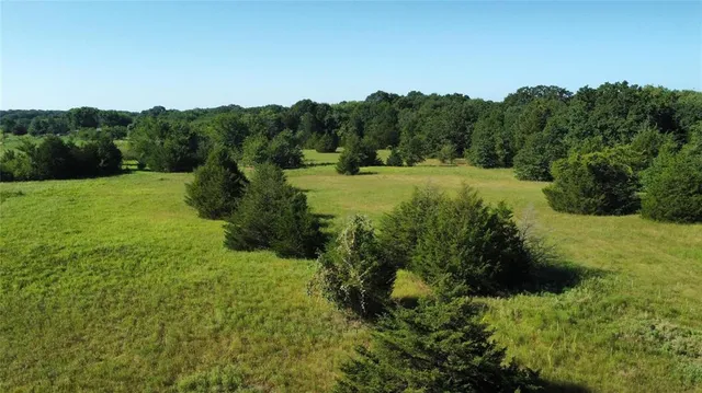 an aerial view of residential houses with outdoor space and river