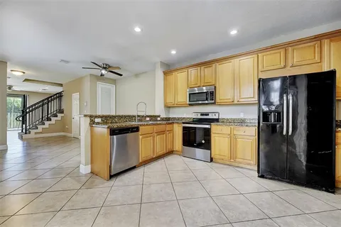 a kitchen with a sink a counter top space and appliances
