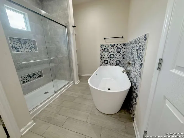 a bathroom with a bathtub and shower