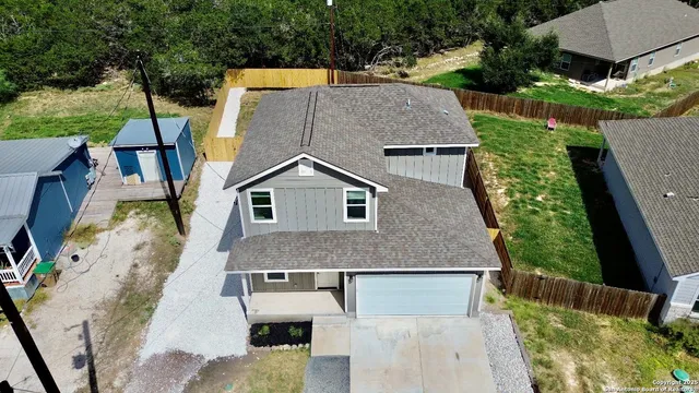 an aerial view of a house with a yard