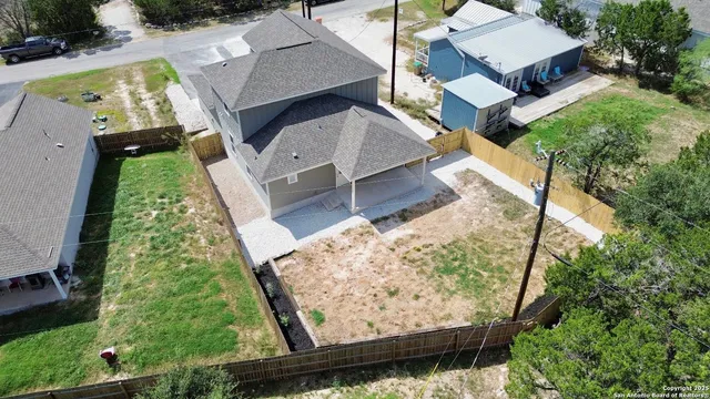 an aerial view of house with yard