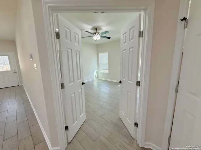 wooden floor in a hall with an entryway door