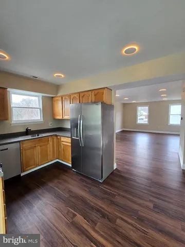 a kitchen with stainless steel appliances granite countertop a refrigerator a sink and a stove