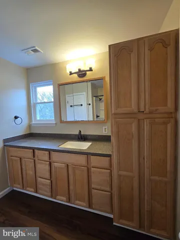 a bathroom with a toilet and a mirror