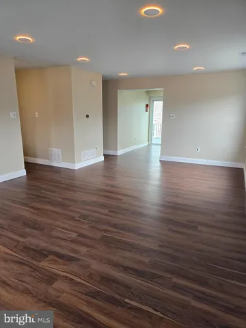 a view of a room with wooden floor